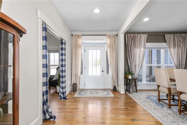 entrance foyer with baseboards, wood finished floors, and recessed lighting