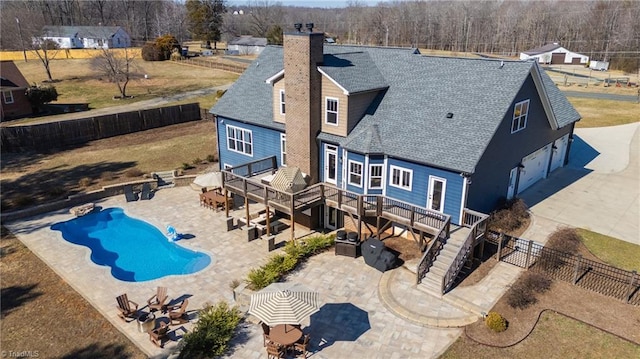 view of swimming pool featuring a patio, a fenced backyard, stairway, a wooden deck, and a fenced in pool