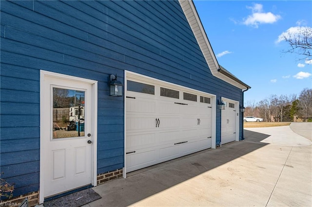 garage with concrete driveway