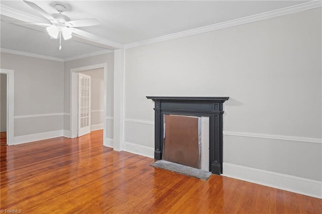 unfurnished living room featuring hardwood / wood-style floors, ceiling fan, and crown molding