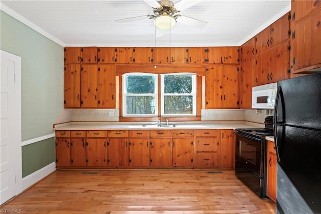 kitchen with light wood-type flooring, tasteful backsplash, crown molding, and black appliances