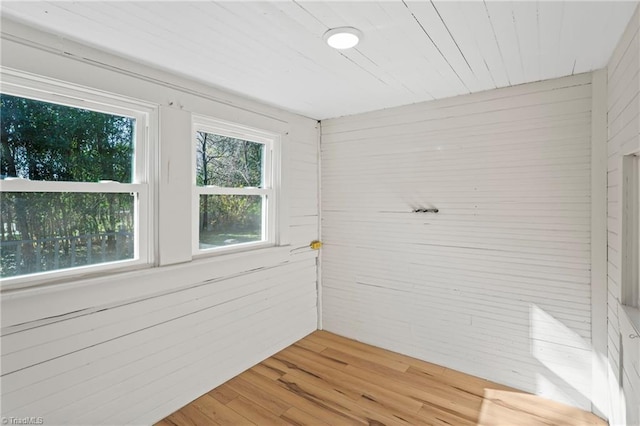 bathroom featuring hardwood / wood-style floors and wood walls