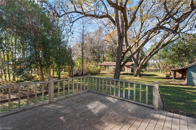 wooden deck featuring a yard