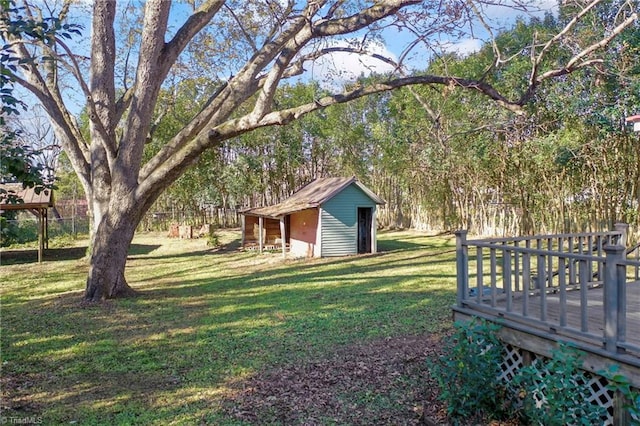 view of yard featuring a shed and a wooden deck