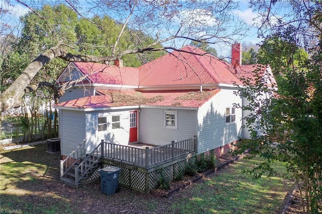 back of house with central AC and a deck