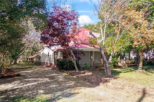 view of property exterior featuring covered porch