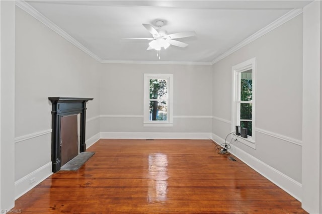 unfurnished living room featuring ceiling fan, hardwood / wood-style floors, and ornamental molding