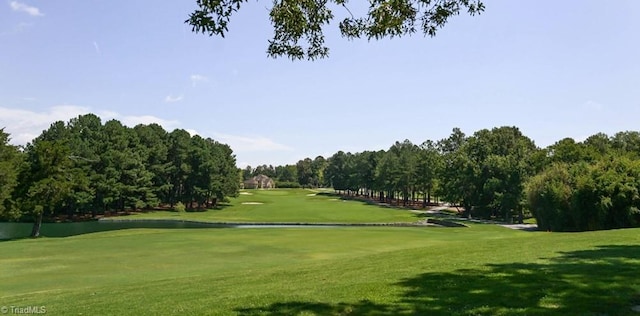 view of community featuring a yard and golf course view