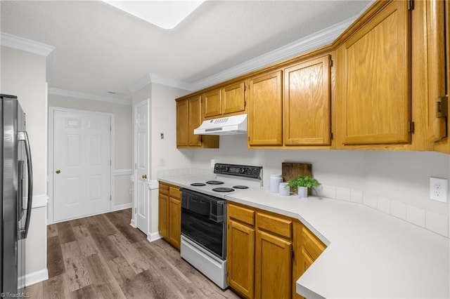 kitchen featuring freestanding refrigerator, ornamental molding, white electric range oven, light countertops, and under cabinet range hood