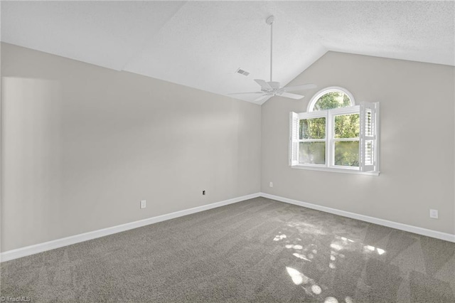unfurnished room featuring carpet floors, ceiling fan, baseboards, and lofted ceiling
