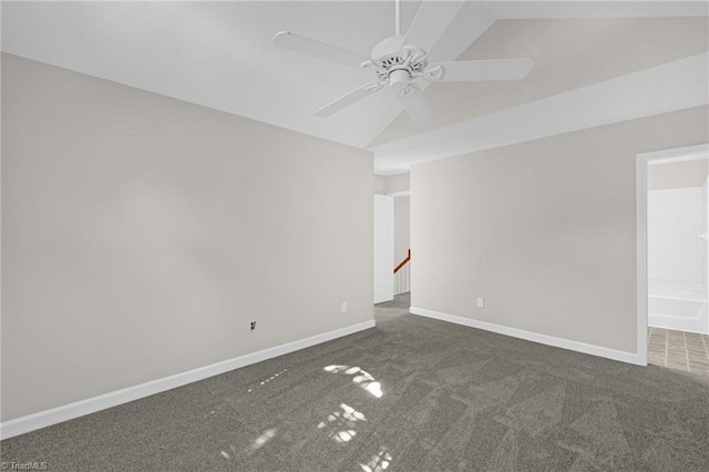 carpeted empty room with baseboards, ceiling fan, and lofted ceiling