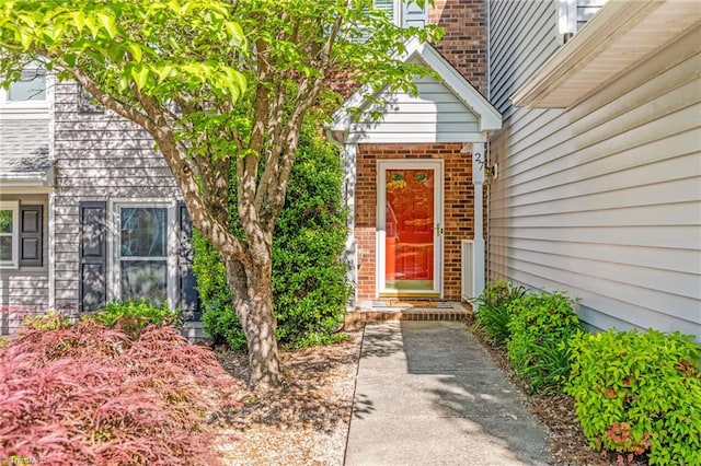 property entrance with brick siding