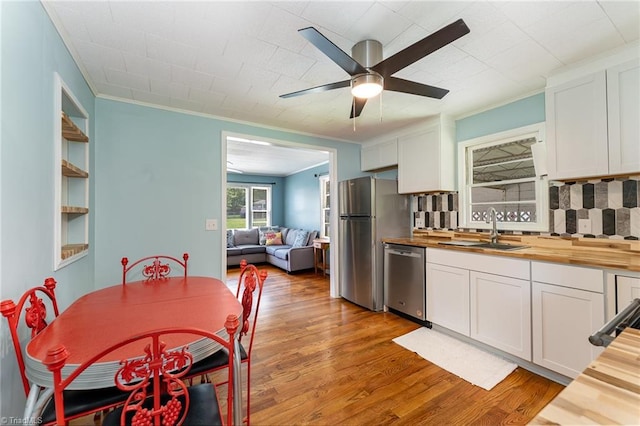 1607 Belmont St, Burlington, NC 27215 - kitchen with butcher block counters, appliances with stainless steel finishes, white cabinetry, ceiling fan, and light wood-style floors