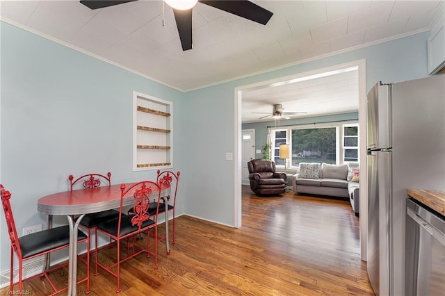 1607 Belmont St, Burlington, NC 27215 - dining space with ceiling fan, ornamental molding, and wood finished floors