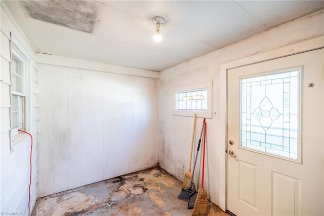 entryway with wood walls