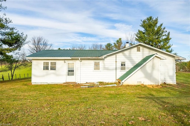 rear view of property with a yard