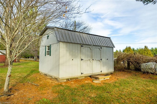 view of outdoor structure with a lawn