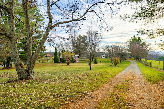 view of community featuring a yard and a rural view