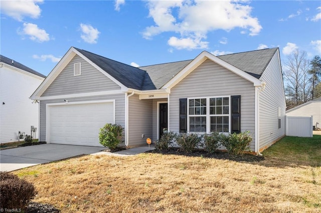 ranch-style house featuring a garage and a front yard