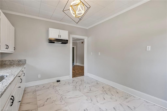 unfurnished dining area with crown molding