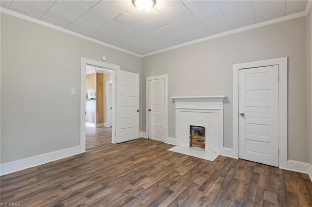 unfurnished living room featuring ornamental molding and dark hardwood / wood-style floors