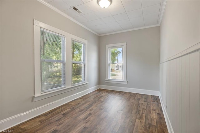 unfurnished room with dark wood-type flooring and ornamental molding