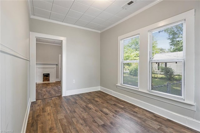 unfurnished room featuring crown molding and dark wood-type flooring