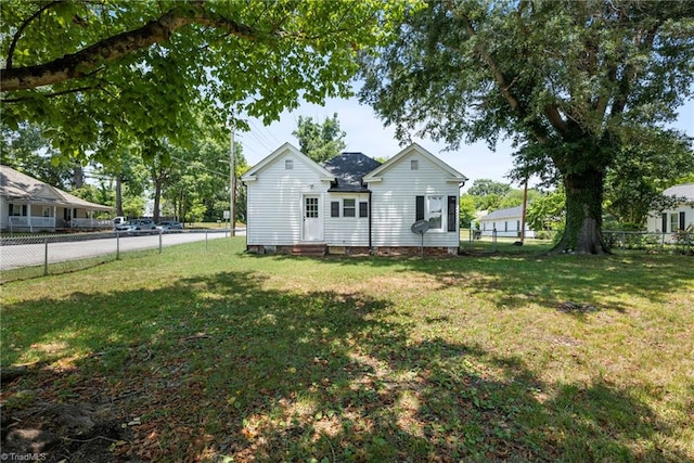 rear view of property with a lawn