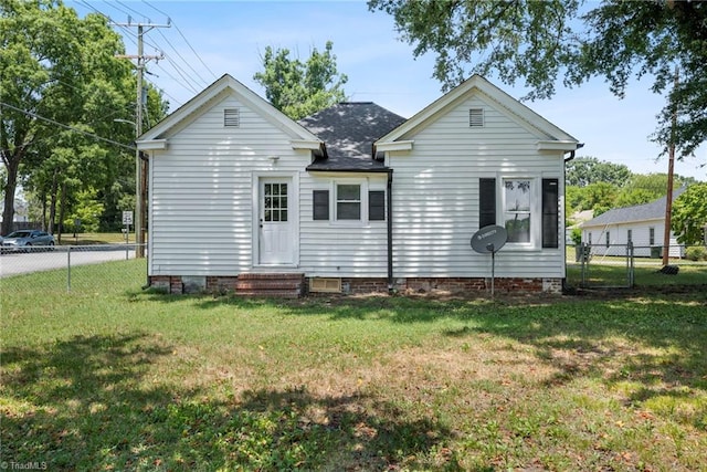 back of property featuring a yard