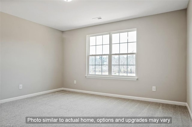 carpeted spare room with baseboards