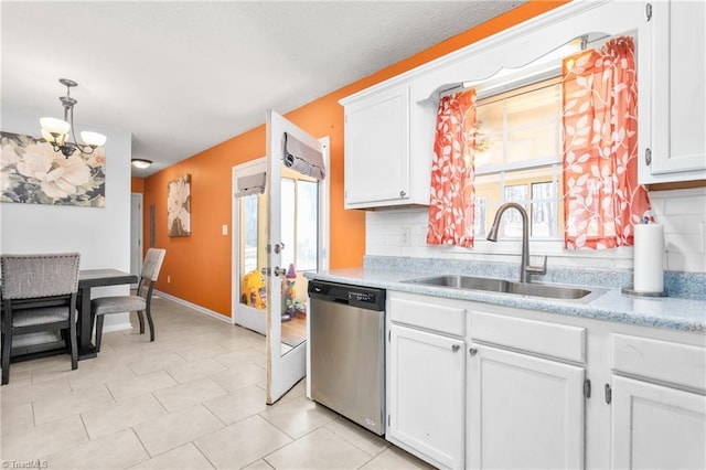 kitchen featuring stainless steel dishwasher, sink, tasteful backsplash, and white cabinets