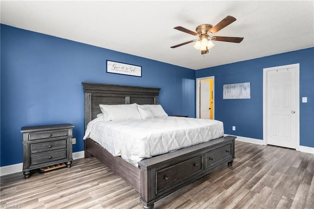 bedroom with ceiling fan and hardwood / wood-style floors