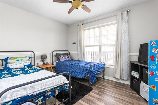 bedroom featuring ceiling fan and dark hardwood / wood-style flooring