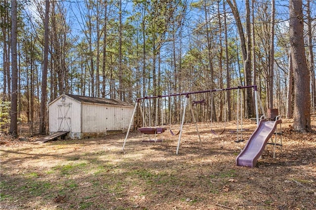 view of yard featuring a storage unit and a playground