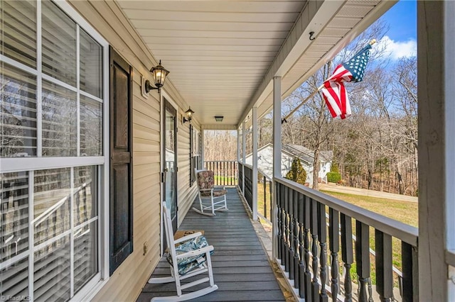 wooden terrace featuring covered porch