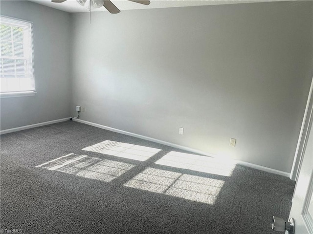 carpeted spare room with baseboards and ceiling fan