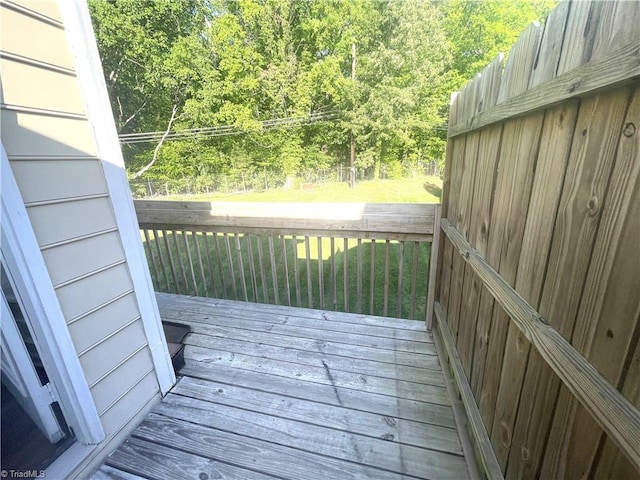 wooden terrace featuring a forest view