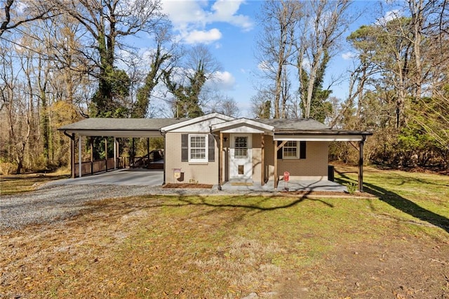 view of front of property with a front yard and a carport