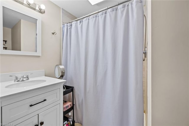 bathroom featuring vanity and walk in shower