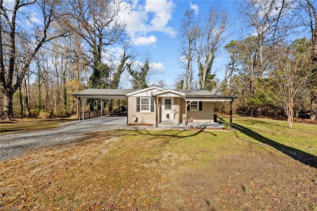 view of front of home with a front yard and a carport