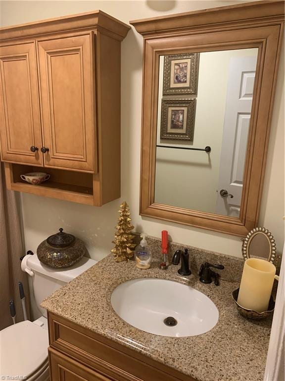 bathroom with vanity and toilet