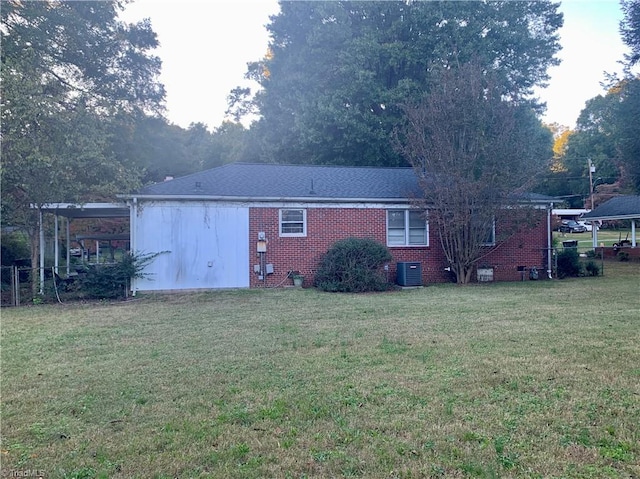 back of property featuring a lawn and central AC unit