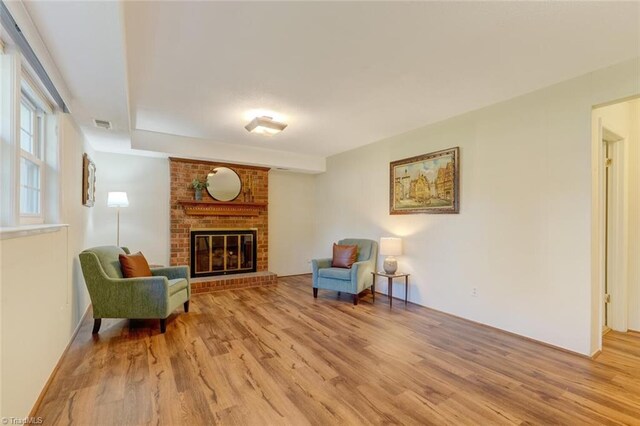 sitting room featuring a fireplace and light wood-type flooring