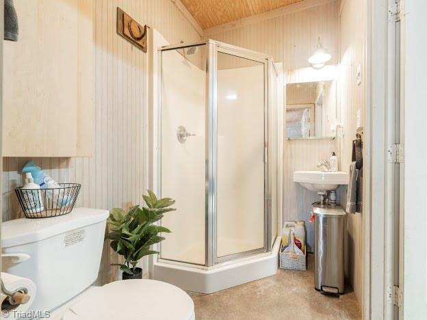 full bathroom featuring a stall shower and toilet