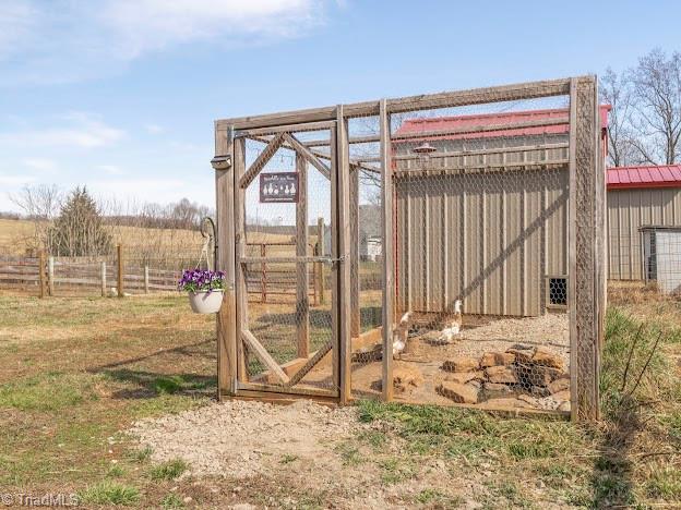 exterior space with fence and an outdoor structure