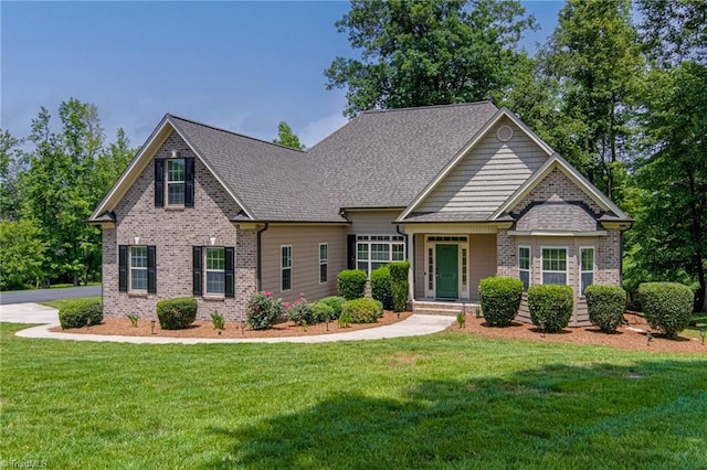 3001 Walbrook Ter, Browns Summit, NC 27214 - craftsman inspired home with brick siding, a front yard, and a shingled roof