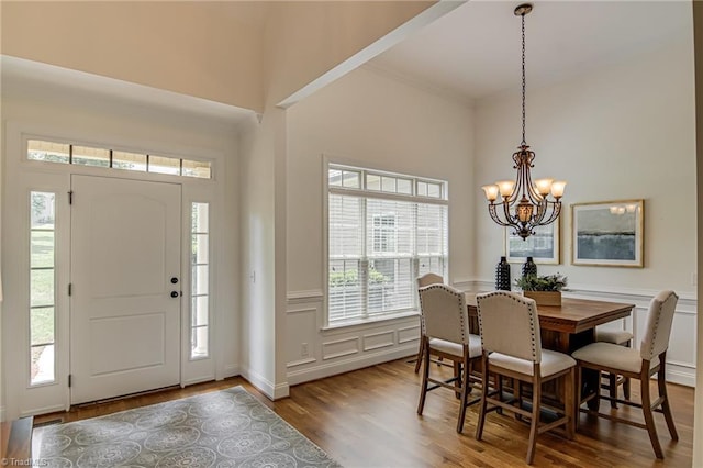 3001 Walbrook Ter, Browns Summit, NC 27214 - foyer with a chandelier, wood finished floors, a wainscoted wall, a decorative wall, and a high ceiling