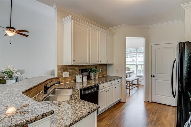 3001 Walbrook Ter, Browns Summit, NC 27214 - kitchen featuring black appliances, a sink, backsplash, light wood-type flooring, and stone countertops