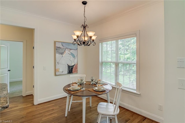 3001 Walbrook Ter, Browns Summit, NC 27214 - dining space featuring a chandelier, baseboards, crown molding, healthy amount of natural light, and wood finished floors
