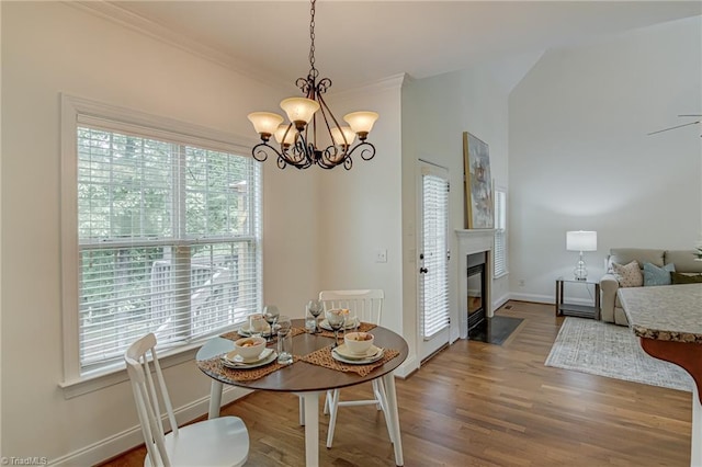 3001 Walbrook Ter, Browns Summit, NC 27214 - dining space featuring healthy amount of natural light, a chandelier, baseboards, wood finished floors, and ornamental molding